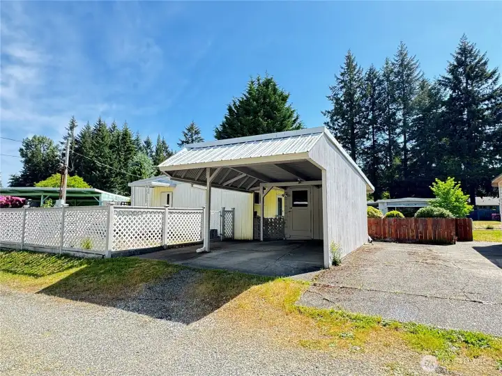 Carport with shed and driveway