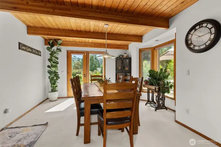 Dining room with door to the deck on the east side of home. Dining room with door to the deck on the east side of home.