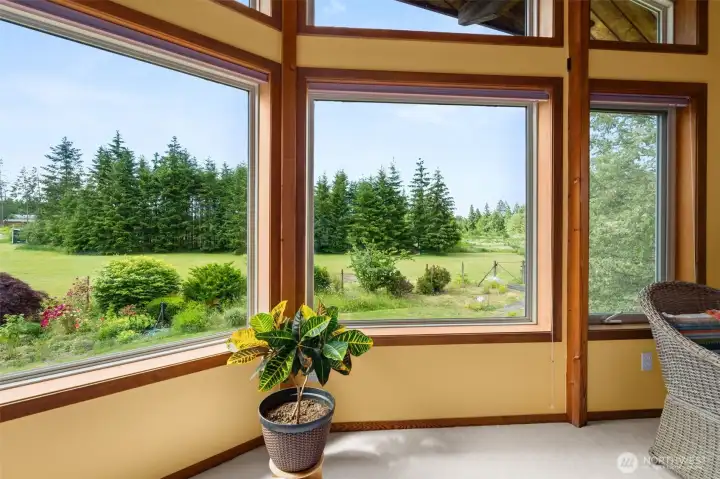 View from primary suite facing south. The trees in the background are on the property. View from primary suite facing south. The trees in the background are on the property.