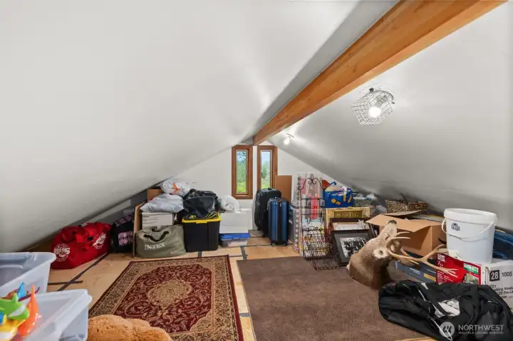 Attic space - mostly finished. Entry from primary bathroom through short door (how very Alice in Wonderland). Attic space - mostly finished. Entry from primary bathroom through short door (how very Alice in Wonderland).