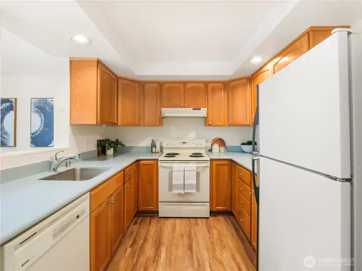 The heart of daily routines, this well-designed kitchen offers abundant storage, ample workspace, and a practical layout that makes meal preparation and hosting effortless.