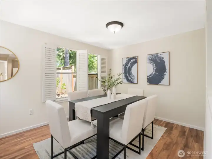 Bright and inviting dining area with large windows, natural light, and a comfortable setting for everyday meals and memorable gatherings.