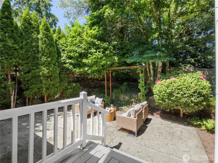 Step outside and enjoy your own outdoor retreat, where a spacious patio is surrounded by mature landscaping and lush greenery. Whether