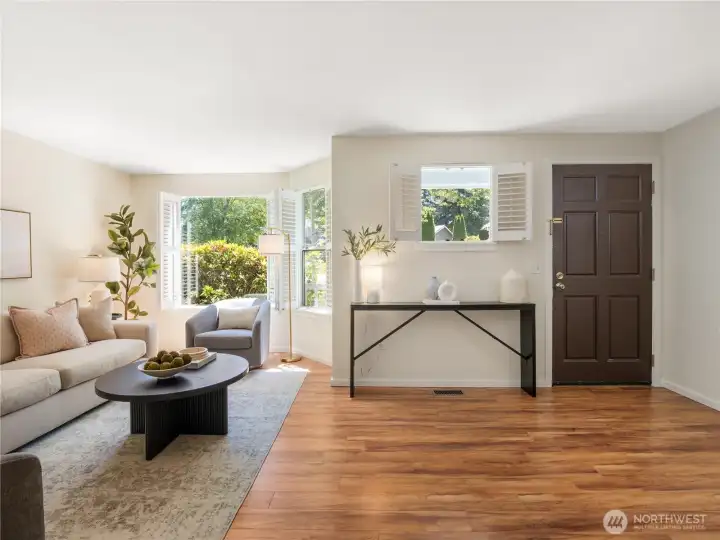 Sunlight streams through expansive windows, creating a bright and uplifting space to relax, recharge, or gather with guests.