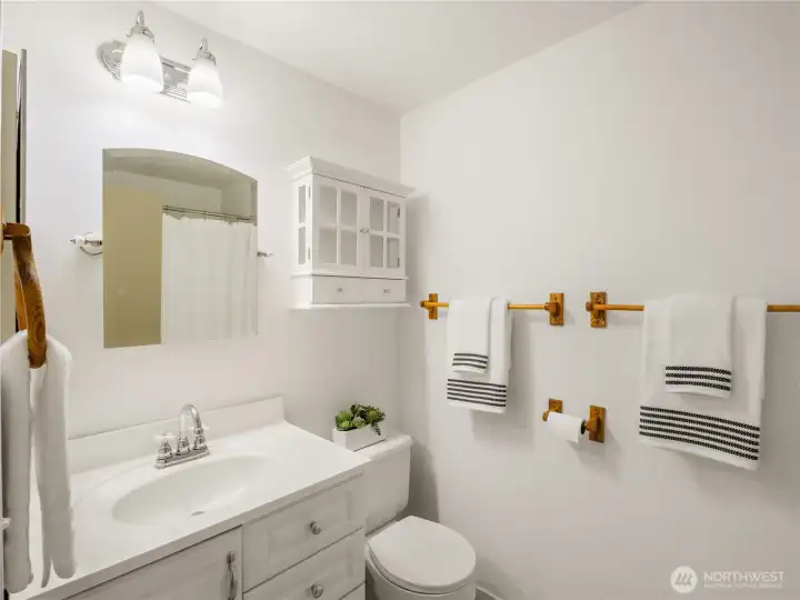 Bright and inviting bath featuring clean finishes, convenient storage, and a comfortable setting for everyday routines.