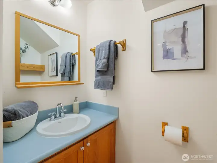 This powder room adds comfort and functionality to everyday living and entertaining, offering an easily accessible space for guests and daily routines.