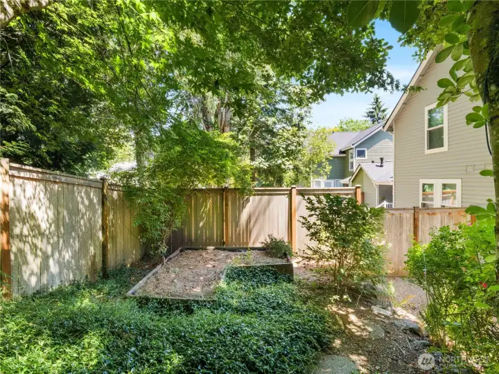 Enjoy the garden area tucked within the backyard, offering flexibility for seasonal planting and outdoor enjoyment.