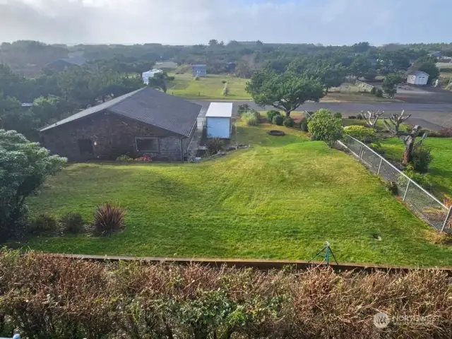 View from deck over the back yard and shop to the ocean.