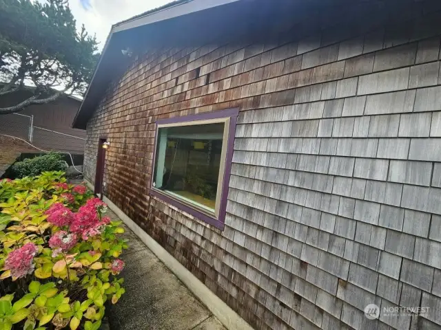 Entry to the shop with beautifully landscaped grounds.