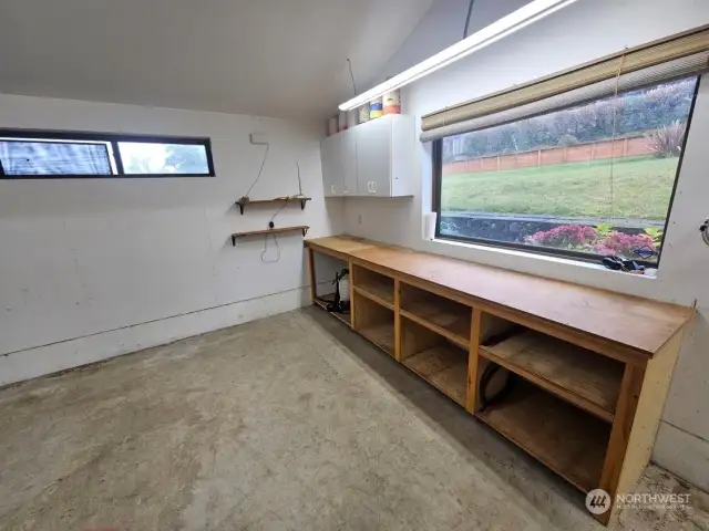 Workbench with lots of natural light in the back section of the shop.