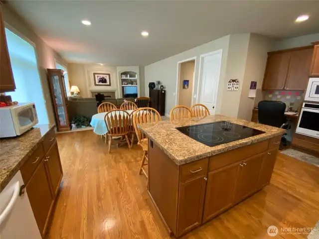 Photo taken by Seller prior to Tenant Occupancy. Functional island workspace with cooktop