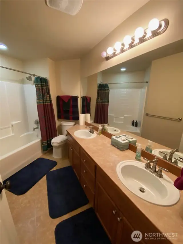 Photo taken by Seller prior to Tenant Occupancy.  Full bath upstairs with double sinks