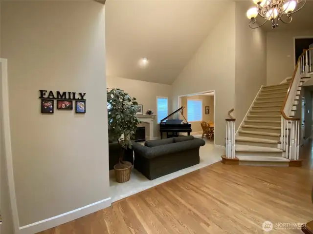 Photo taken by Seller prior to Tenant Occupancy. Elegant curved stairs grace the entry adjacent to the formal living room