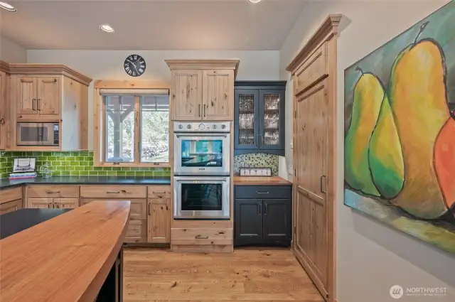 Custom Cabinets and hardware, 2" Walnut Slab island. TV above the microwave