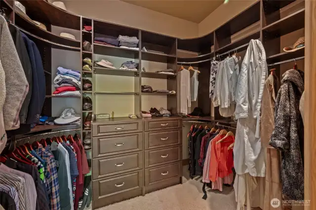 Built in custom closets with a secret pass through to the laundry room