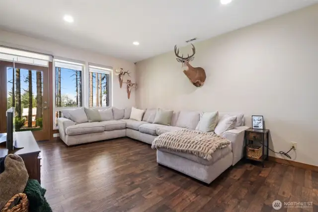 Large family room on the lower level with sliders out to the covered patio