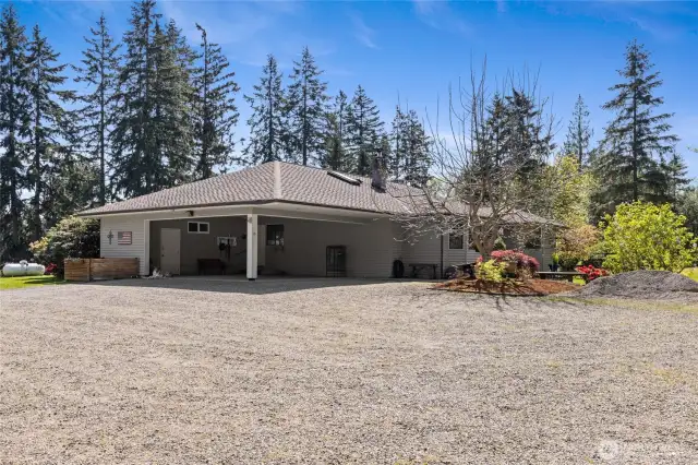 The attached Portico is oversized and does hold 2 large vehicles with room to spare. There is the Storage area that holds extra anything, as well as the Home's Systems Center. Lot's of room for a Freezer and Extra Items in there.