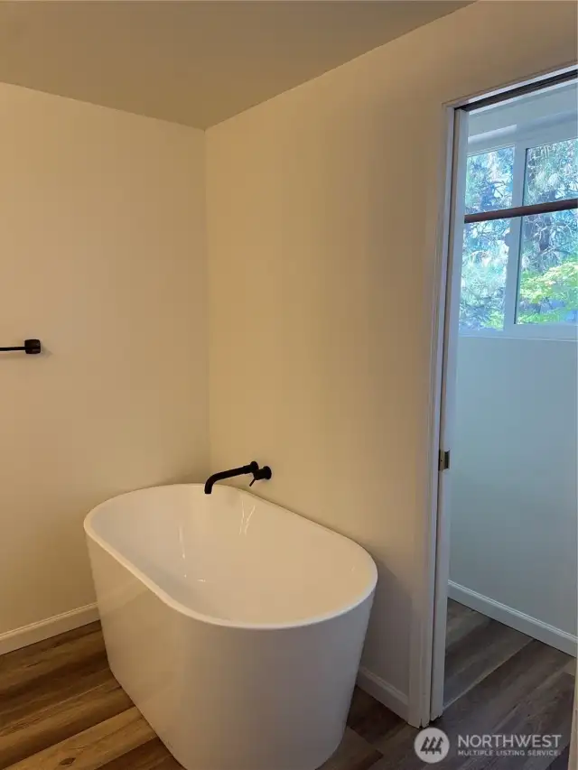 Ensuite soaking tub and a walk-in closet