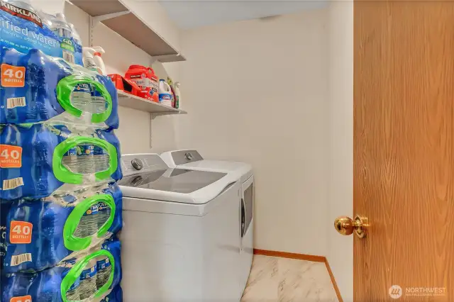 Laundry room with built-in shelving and brand-new tile flooring for a fresh, clean look.