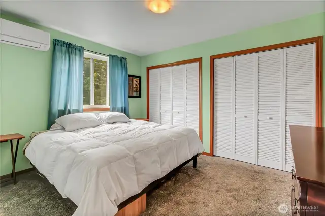 Primary bedroom offers brand-new carpeting, a mini-split system for comfort, ample closet space, and the convenience of an attached bathroom with shower, sink, and toilet.