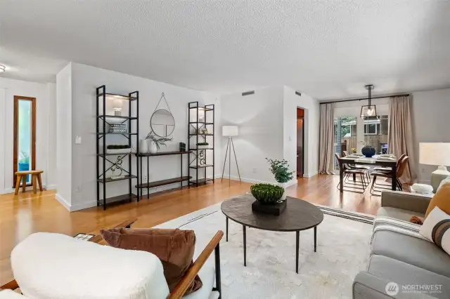 The front door is next to the window on the left. The kitchen is across from the dining table. The wall closing off the kitchen is not load bearing and could be removed.