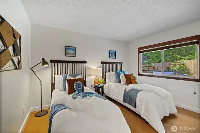 Bedroom #1. It's a large space with a large closet on the wall opposite the beds.