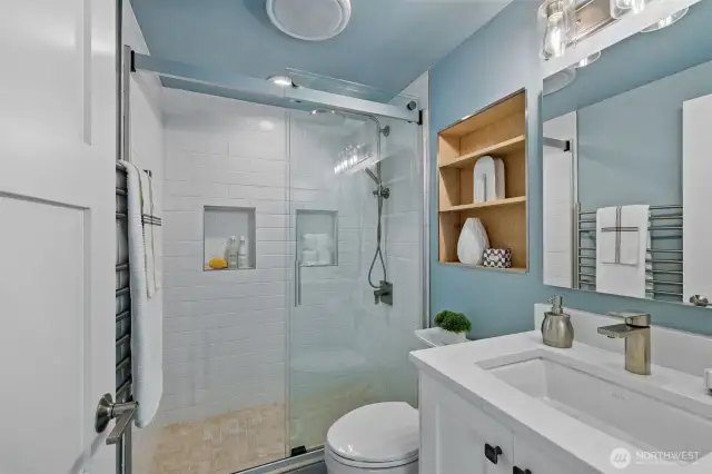 Another spa-like bath. Primary bath was also remodeled in 2023. There's more storage behind the mirror and a heated towel rack.
