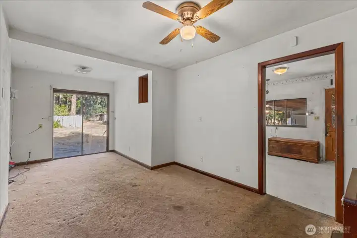Large dining area leading to a concrete patio.