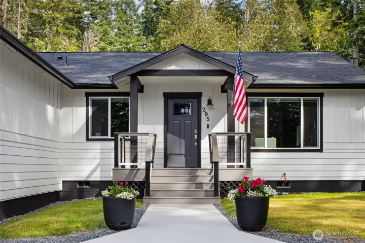 A welcoming front entry with modern black-and-white finishes sets the tone for this 2023-built Westcott Bay home.