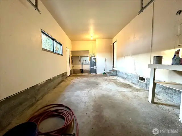 Fairly deep garage. Exterior door on the left. Kitchen door on the right, W/D hookup.