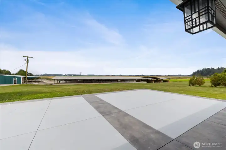 Paved patio overlooks farm and farmland