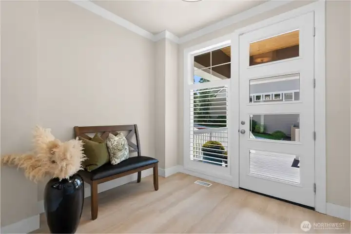 A bright contemporary foyer greets you as you step inside.  Brand new flooring throughout gives it an entirely fresh look and appeal.