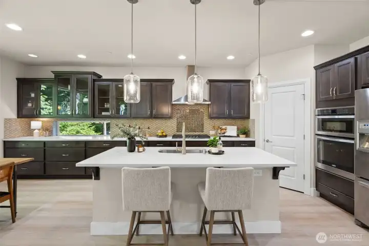 Cabinets galore in this terrific kitchen!  Quartz counters and stylish pendant lighting over the island