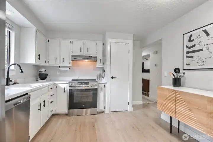 Kitchen features brand-new stainless appliances and hardware.