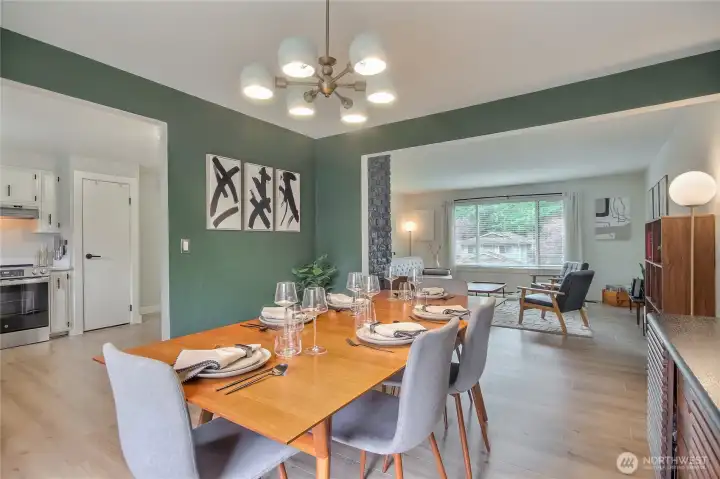 Dining room off of the kitchen and living room with new flooring and designer lighting.