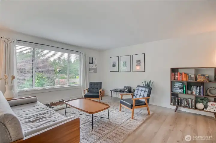 Living room has tons of natural lighting and fireplace.