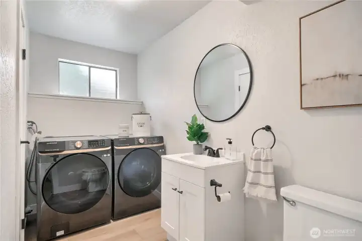 Laundry room downstairs with half bathroom.