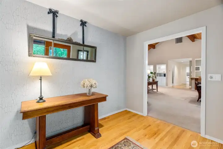 Welcome in to a proper foyer, with warm hardwood flooring