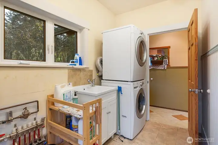 Functional utility room with generous storage options and utility sink.