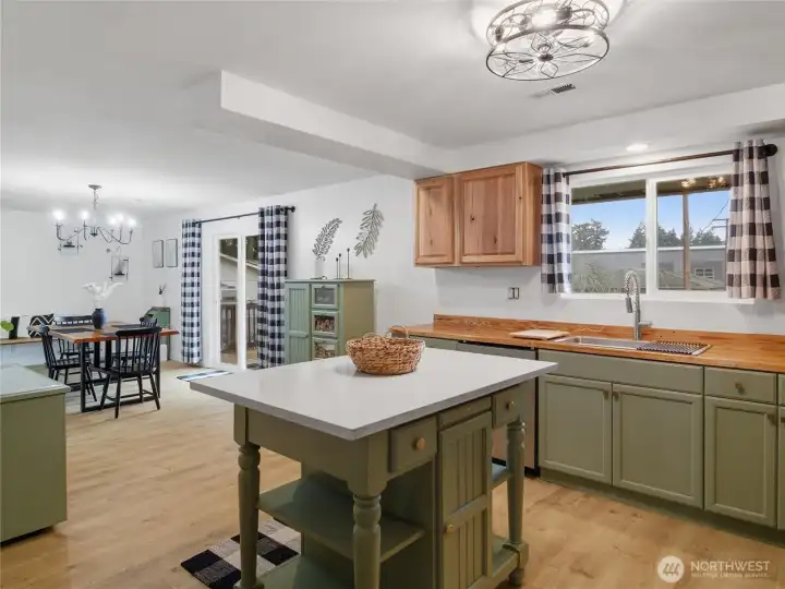 View from kitchen to 2nd dining area and sliding door to the backyard deck.