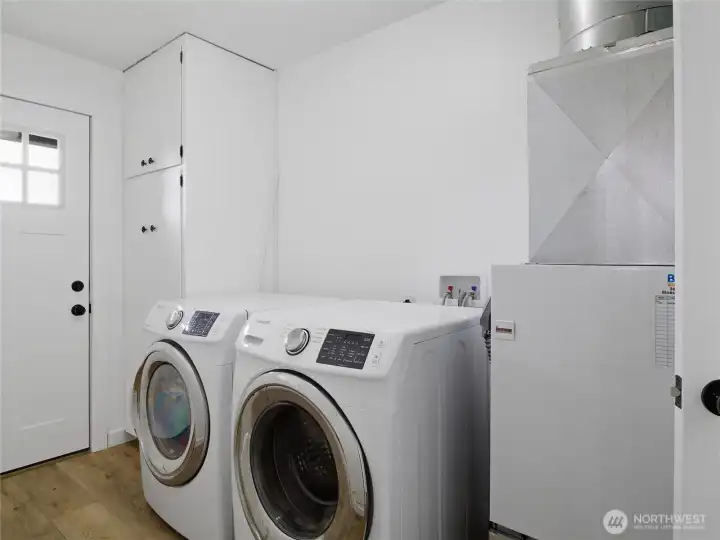 Utility room with exterior door to the back deck.