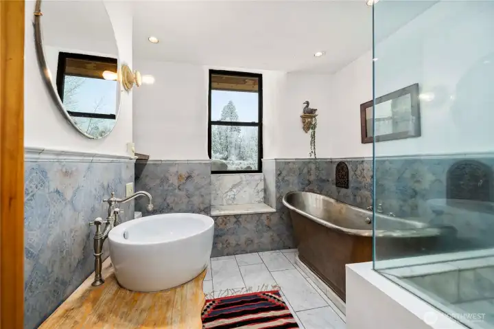 18th-century French copper bathtub, German hand-stenciled tile, and Carrera marble.