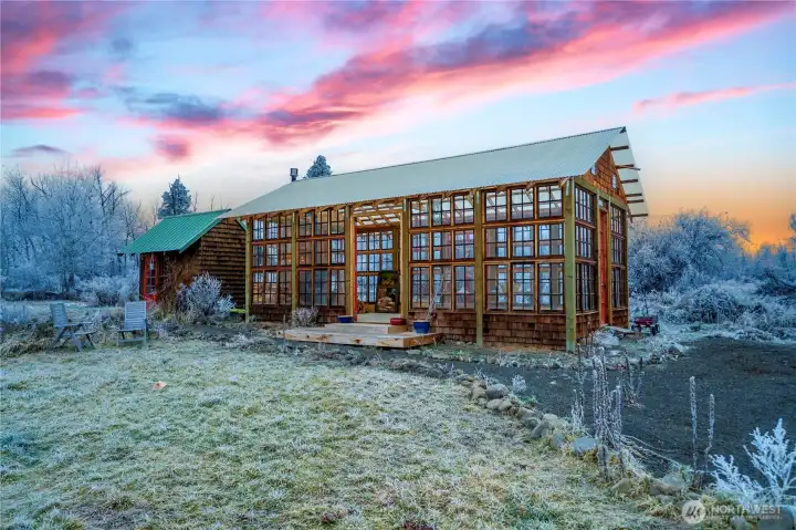 greenhouse built with 1900s farmhouse doors and a vintage stove