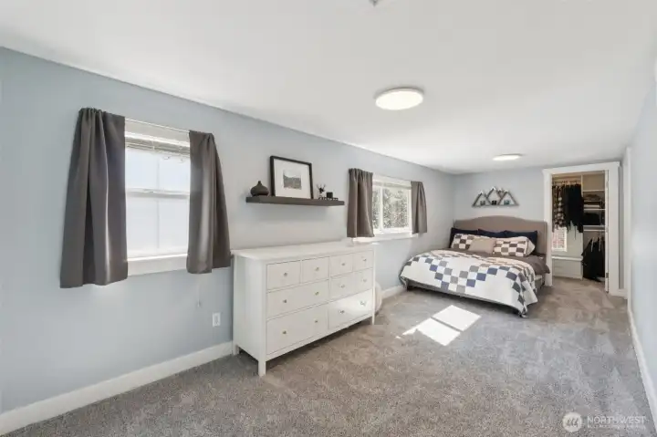 Primary bedroom with private deck, en suite bath and walk in closet.