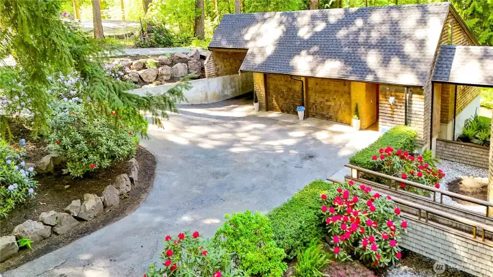 Main entry bridge over moat. Gorgeous Rhododendrons showcased across property.