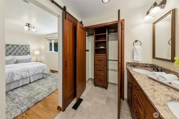 Primary bathroom. Notice to solid wood  barn door and closet doors.