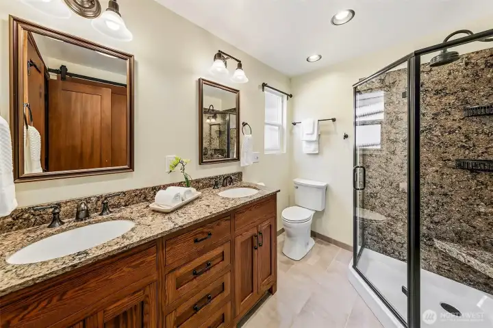 Bathrooms are updated with solid surface counters, undermount sinks, hardwood cabinets, high-end fixtures & ceramic tile floors.
