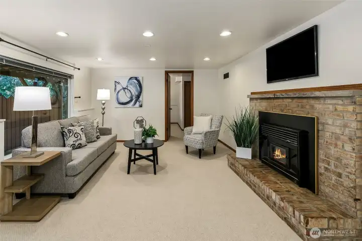 Family room has new wool carpet, wood burning fireplace and recessed lighting.