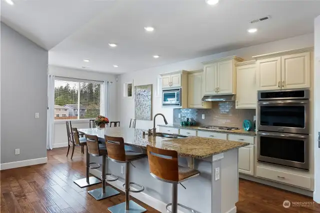 Chef's kitchen..with granite counters, stainless steel appliances, double ovens, microwave, gas cooktop, and walk-in pantry