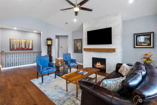 Main level Great Room with gas fireplace and ceiling fan